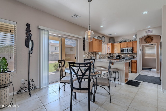 dining room featuring baseboards, visible vents, recessed lighting, and light tile patterned floors
