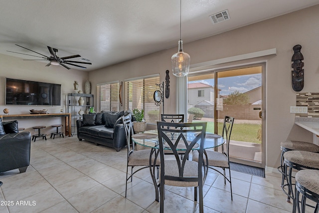 dining area with ceiling fan, light tile patterned flooring, and visible vents