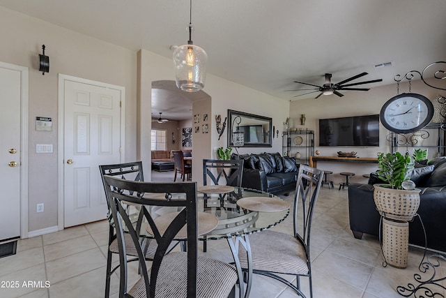 dining space with visible vents, baseboards, ceiling fan, and light tile patterned floors