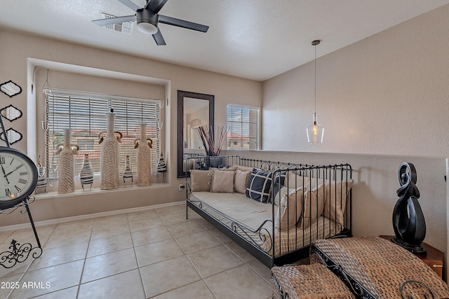 living room featuring ceiling fan, baseboards, light tile patterned flooring, and visible vents