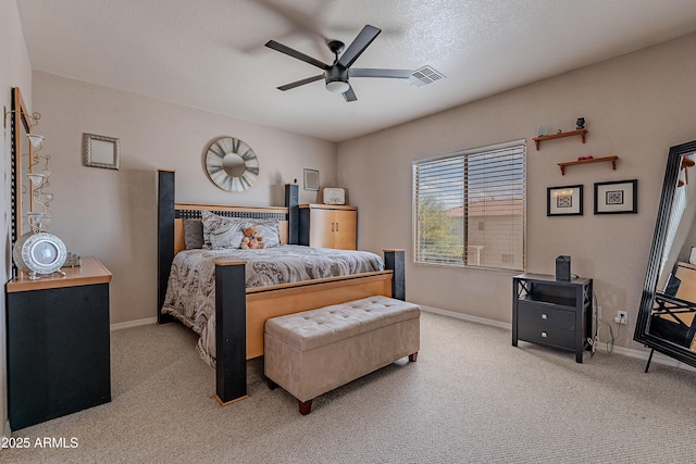 carpeted bedroom with ceiling fan, baseboards, and visible vents
