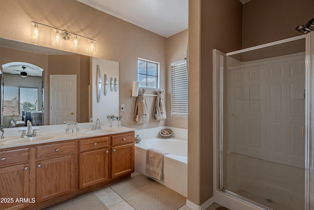 bathroom featuring a garden tub, a sink, ensuite bathroom, and a stall shower