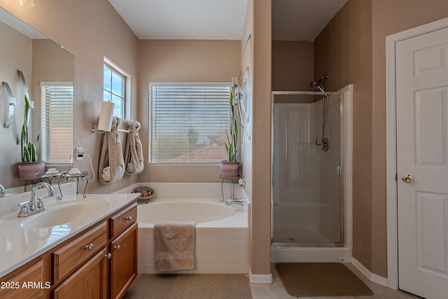 bathroom with a bath, vanity, and a shower stall