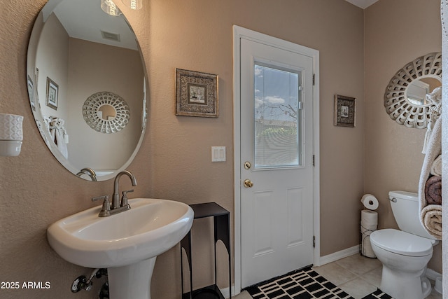 bathroom featuring tile patterned floors, visible vents, a sink, and toilet