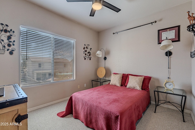 carpeted bedroom featuring a ceiling fan, baseboards, and multiple windows