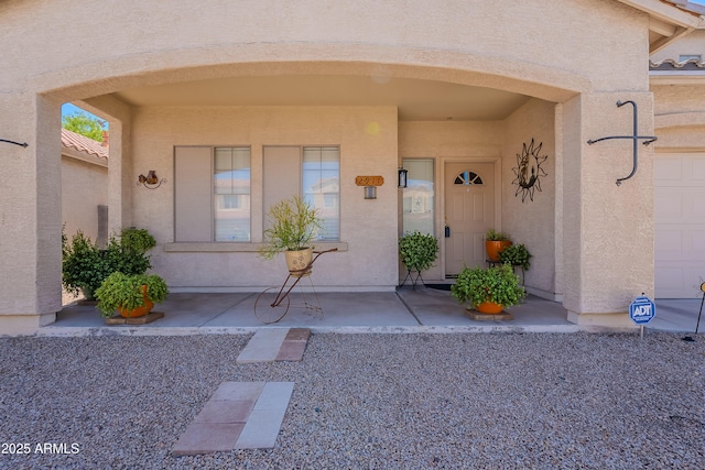 property entrance featuring stucco siding
