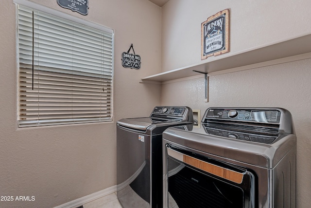 laundry area with washer and clothes dryer and laundry area