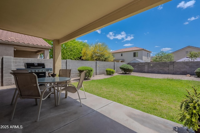view of patio featuring area for grilling, a fenced backyard, and outdoor dining area