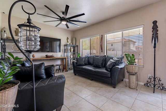 tiled living room with a ceiling fan