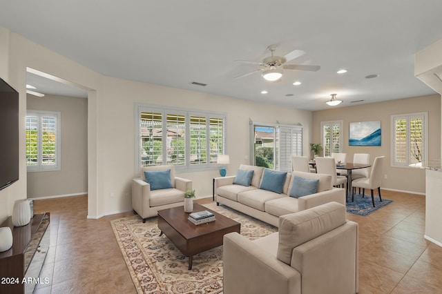 living room with ceiling fan and light tile patterned floors