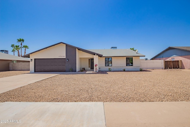 17040 N 39th Ave, Glendale, AZ 85308 - view of front of home with brick siding, driveway, fence, and a garage