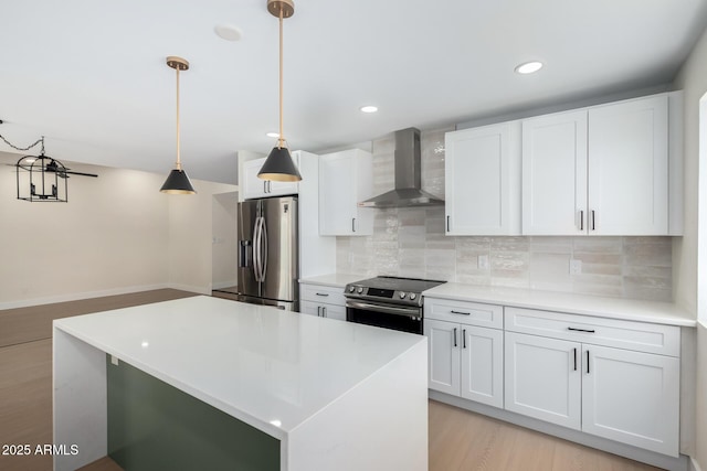 17040 N 39th Ave, Glendale, AZ 85308 - kitchen featuring wall chimney range hood, stainless steel appliances, decorative backsplash, light countertops, and white cabinetry