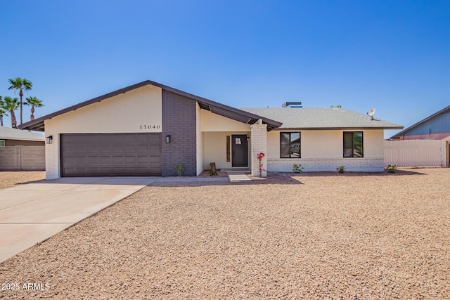 17040 N 39th Ave, Glendale, AZ 85308 - mid-century home with brick siding, an attached garage, fence, and concrete driveway