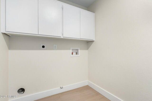 17040 N 39th Ave, Glendale, AZ 85308 - clothes washing area with washer hookup, cabinet space, hookup for an electric dryer, baseboards, and light wood-style floors