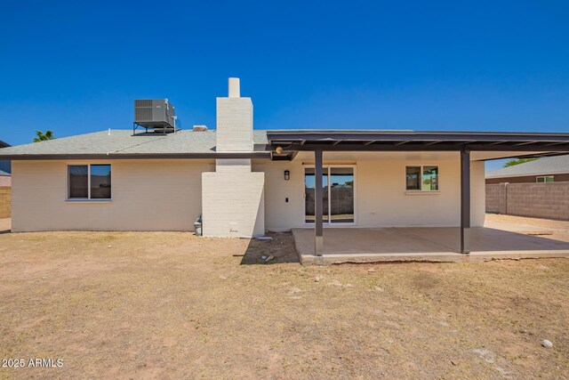 17040 N 39th Ave, Glendale, AZ 85308 - rear view of house with a patio area, a chimney, central AC unit, fence, and brick siding