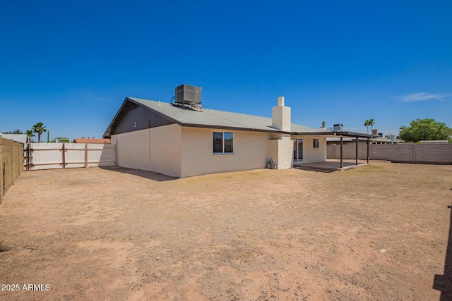17040 N 39th Ave, Glendale, AZ 85308 - rear view of house with a chimney, a fenced backyard, a patio area, and cooling unit
