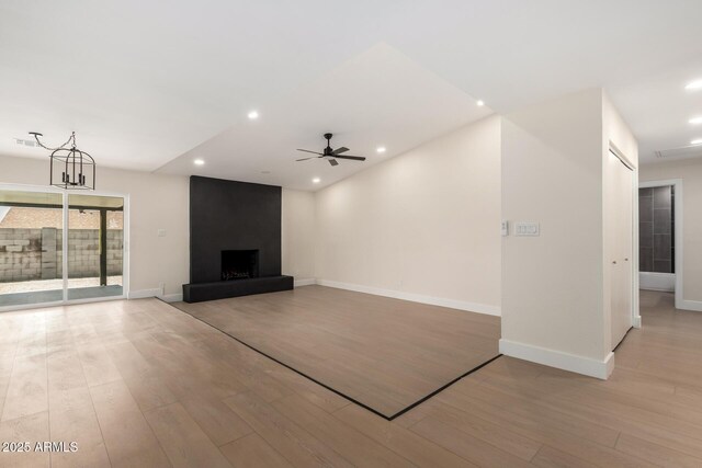 17040 N 39th Ave, Glendale, AZ 85308 - unfurnished living room featuring light wood finished floors, ceiling fan, baseboards, recessed lighting, and a fireplace