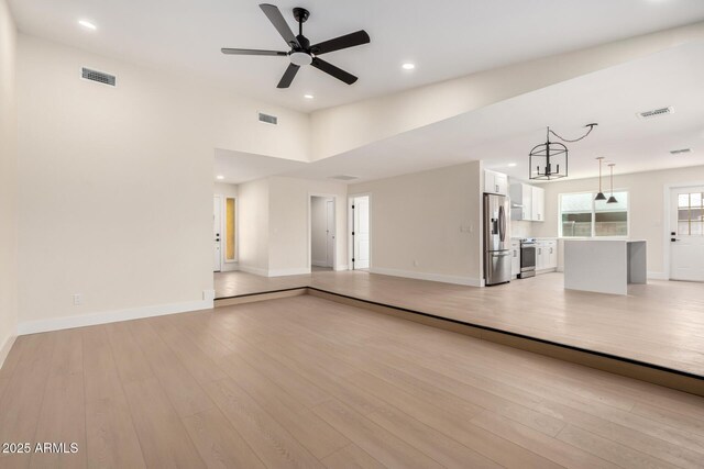 17040 N 39th Ave, Glendale, AZ 85308 - unfurnished living room featuring light wood finished floors, baseboards, ceiling fan, and recessed lighting