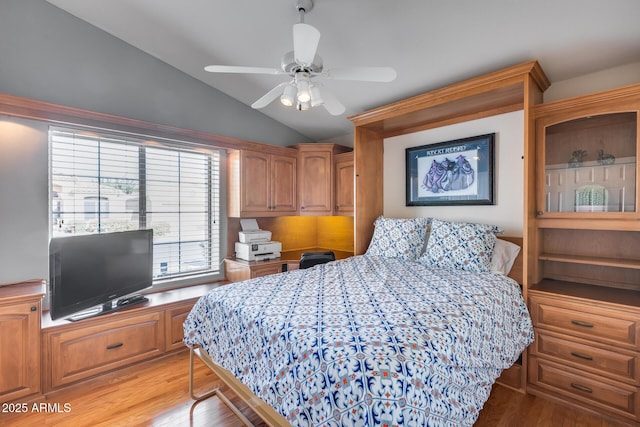bedroom featuring ceiling fan, lofted ceiling, and light wood-style floors