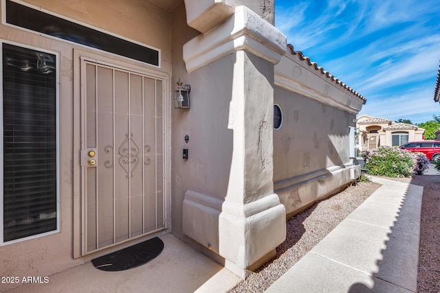 property entrance with stucco siding