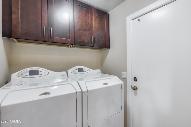 washroom with cabinet space and independent washer and dryer