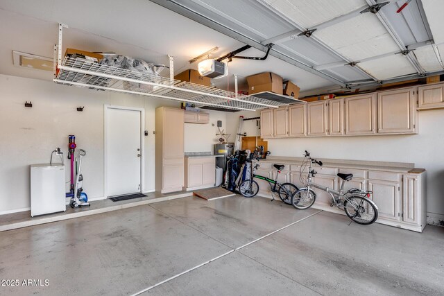 garage with baseboards and a garage door opener