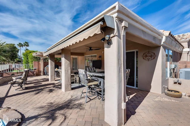 view of patio / terrace with central AC, fence, and a bar