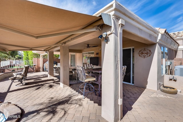 view of patio / terrace featuring cooling unit and fence