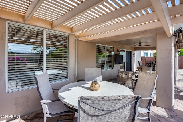 view of patio / terrace with outdoor dining area, a pergola, and a ceiling fan