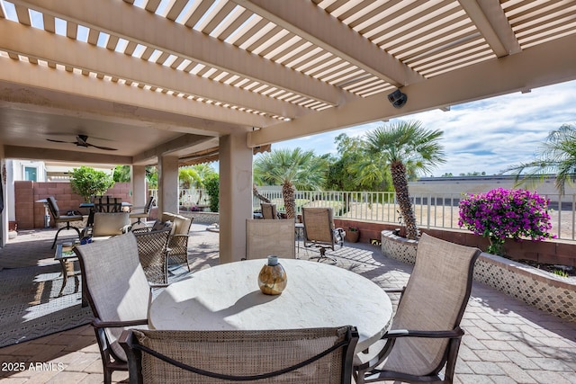 view of patio featuring a pergola, a fenced backyard, ceiling fan, and outdoor dining space