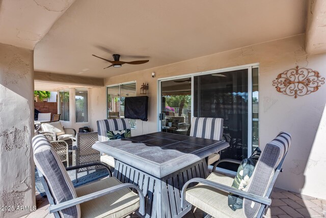 view of patio / terrace with outdoor dining space and a ceiling fan
