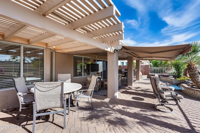 view of patio featuring fence, outdoor dining space, and a pergola