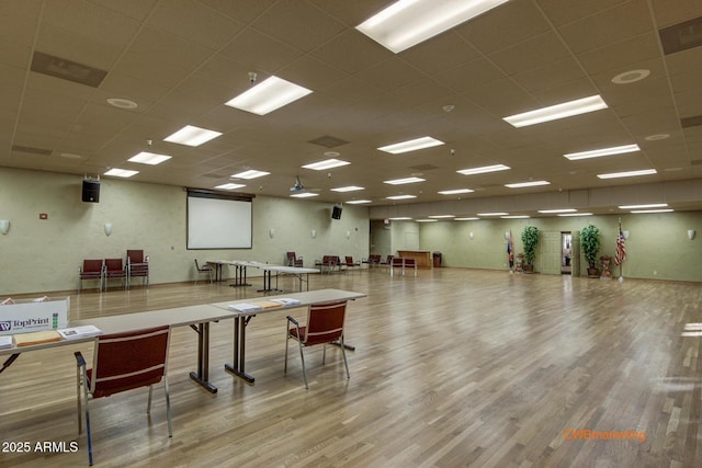 interior space with wood finished floors, visible vents, and a drop ceiling