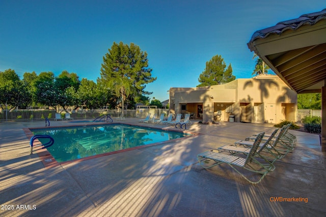 pool featuring a patio and fence