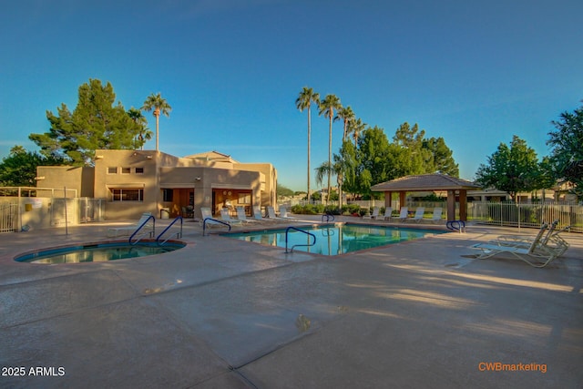 community pool featuring fence, a patio area, and a gazebo