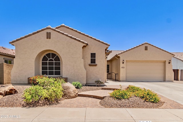 5541 W Desperado Way, Phoenix, AZ 85083 - mediterranean / spanish house with a garage, stucco siding, concrete driveway, and a tiled roof