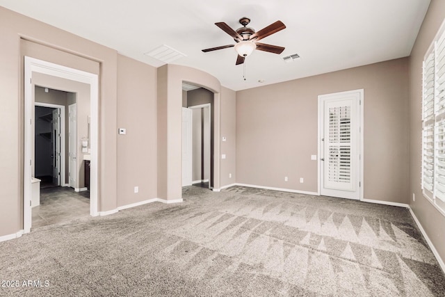 5541 W Desperado Way, Phoenix, AZ 85083 - unfurnished bedroom featuring carpet flooring, baseboards, arched walkways, and a ceiling fan
