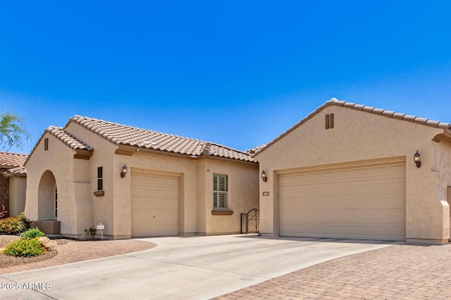 5541 W Desperado Way, Phoenix, AZ 85083 - mediterranean / spanish-style home featuring a garage, driveway, a tiled roof, and stucco siding