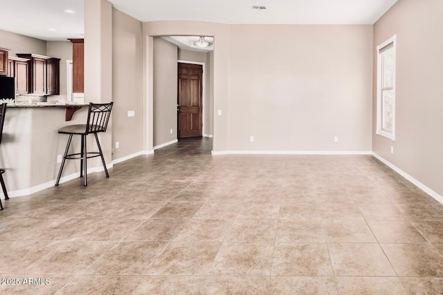 5541 W Desperado Way, Phoenix, AZ 85083 - unfurnished living room featuring light tile patterned floors and baseboards