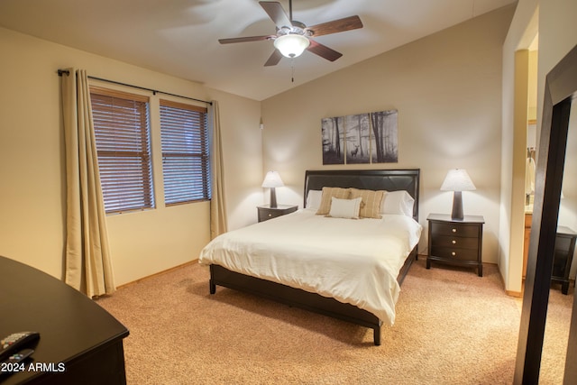 carpeted bedroom featuring vaulted ceiling and a ceiling fan