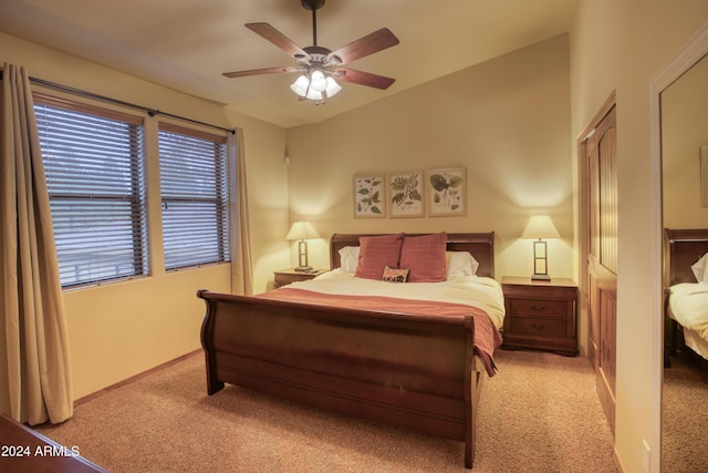 bedroom with carpet, multiple windows, and vaulted ceiling