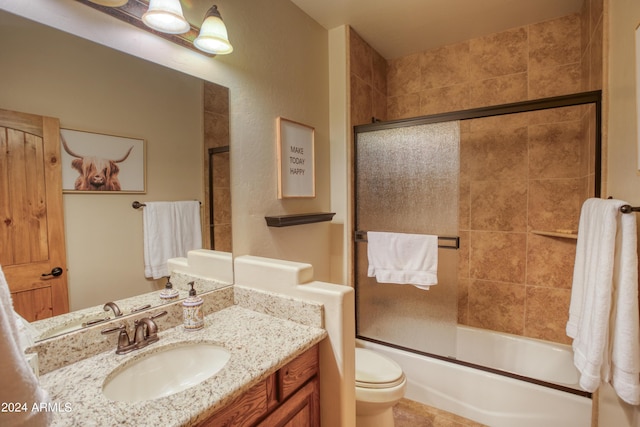 bathroom featuring shower / bath combination with glass door, vanity, and toilet