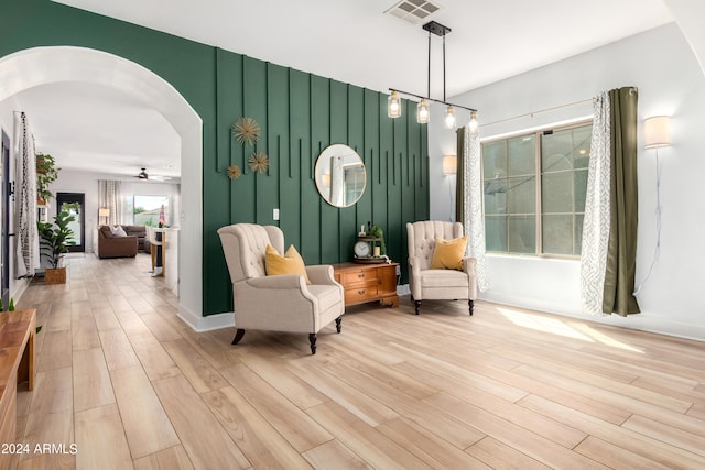 living area with light hardwood / wood-style flooring and ceiling fan