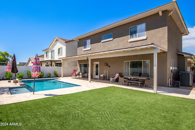 back of house with a patio area, stucco siding, a yard, and a fenced backyard