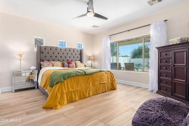 bedroom with ceiling fan and light hardwood / wood-style floors