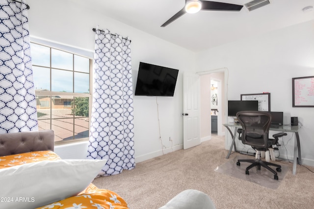 carpeted office featuring visible vents, baseboards, and ceiling fan