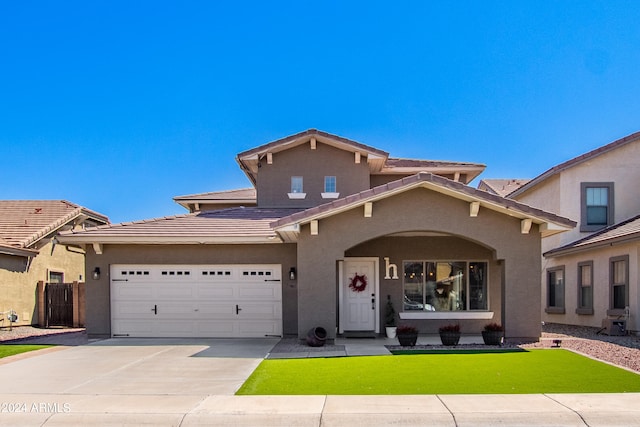 view of front facade with a garage and a front lawn