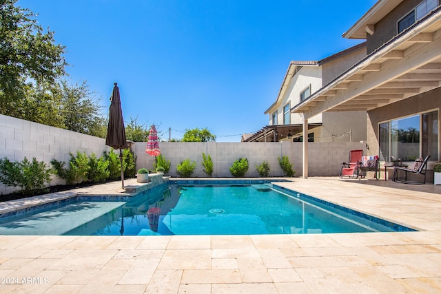 view of swimming pool featuring a fenced in pool, a patio, and a fenced backyard