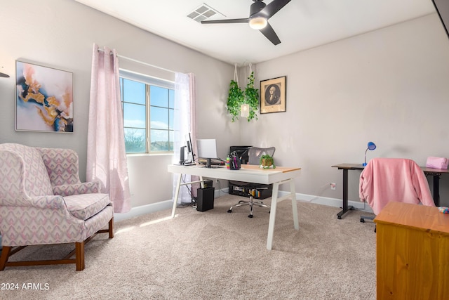 carpeted office featuring baseboards, visible vents, and ceiling fan