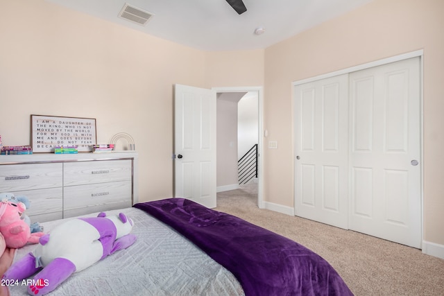 carpeted bedroom featuring a closet and ceiling fan